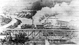 "Wd" class locomotive is crossing the combined road and rail bridge